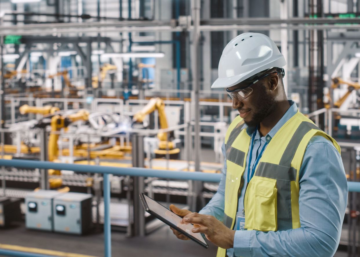 worker using technology application to check the inventory in a warehouse