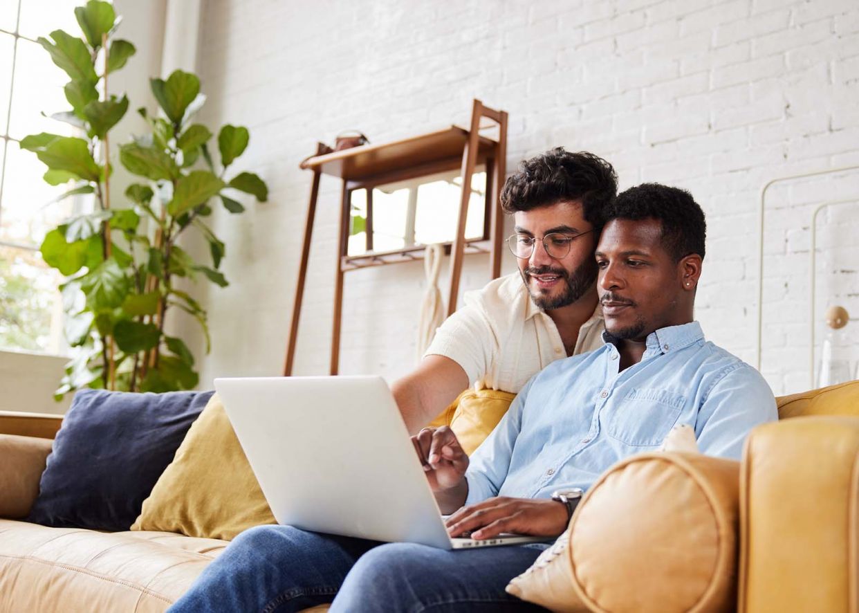 couple looking at laptop booking vacation