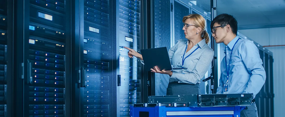 woman and man checking server room