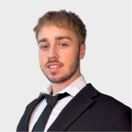 professional photo of Daniil in a suit and tie smiling at the camera