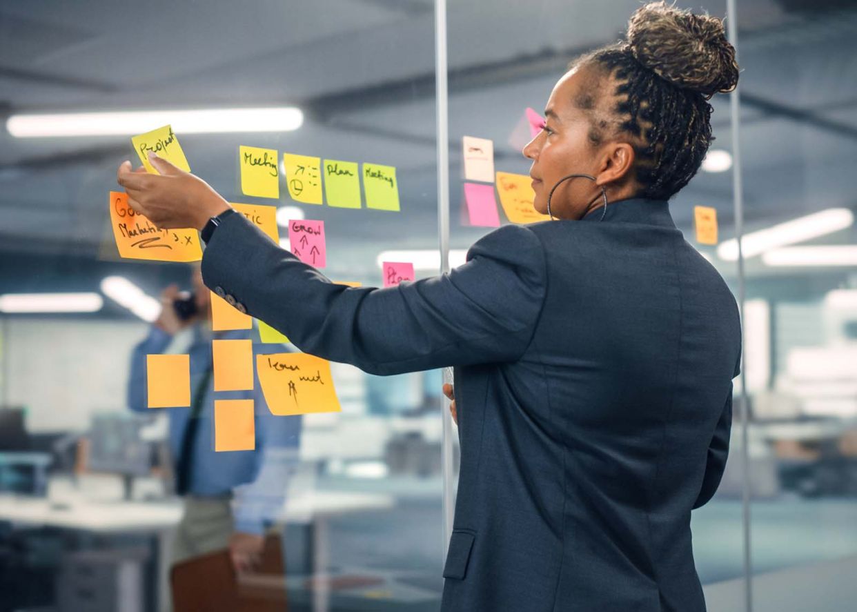 business woman post-it notes managing project