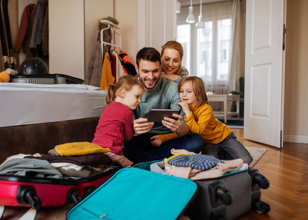family-packing-and-using-tablet-for-travel