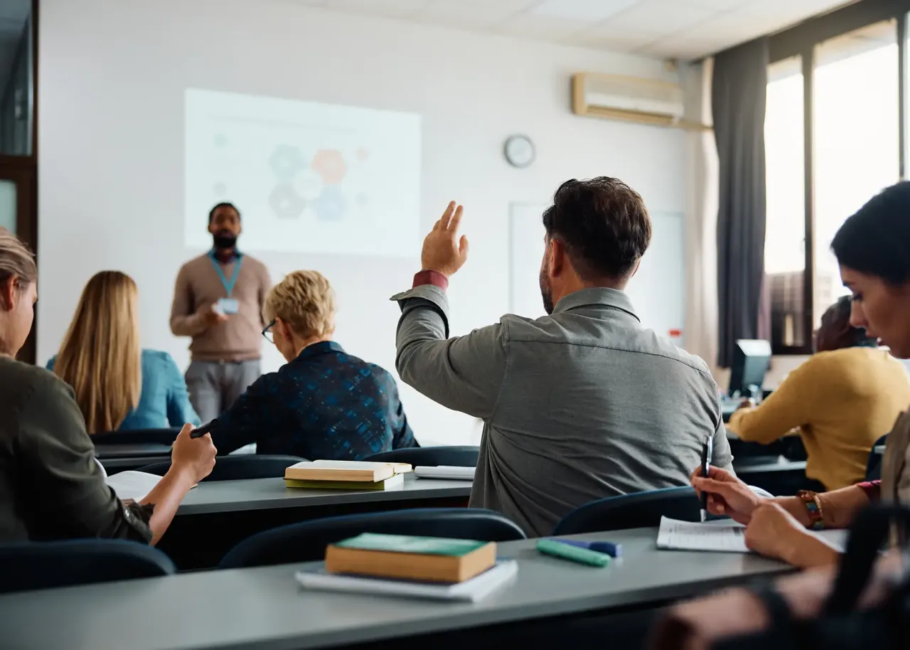 person raising their hand to ask a question