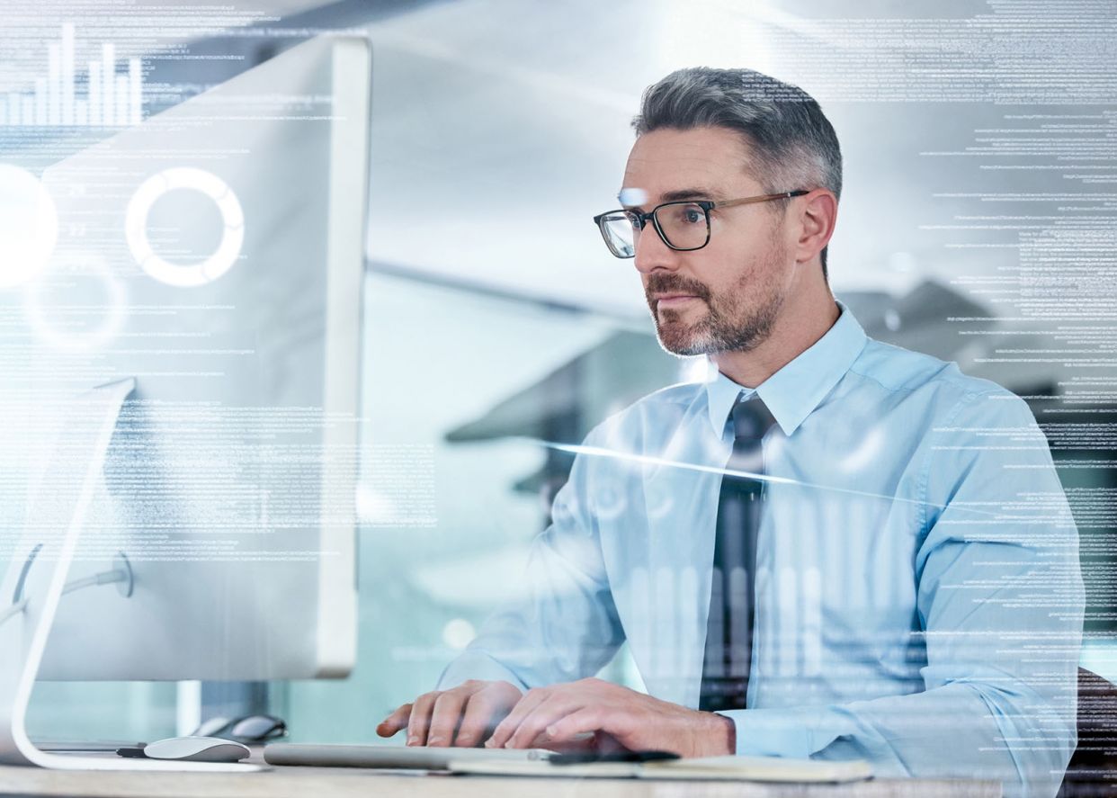 manager-looking-financial-graphs-computer