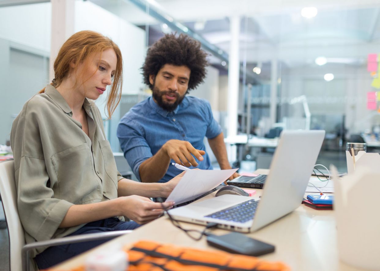 Employees reviewing documentation on inclusion and neurodiversity in the workplace
