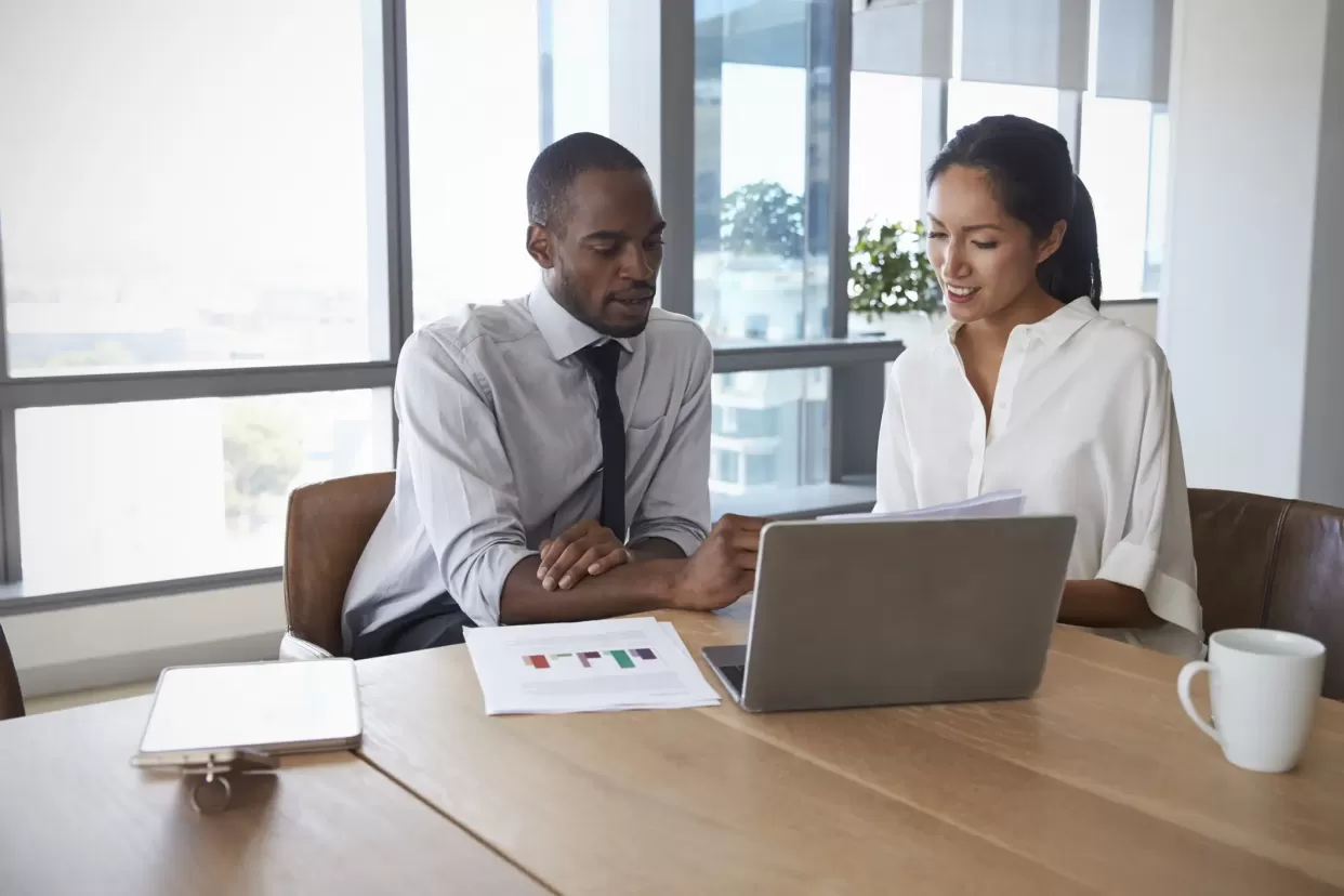 business professionals in meeting looking graph