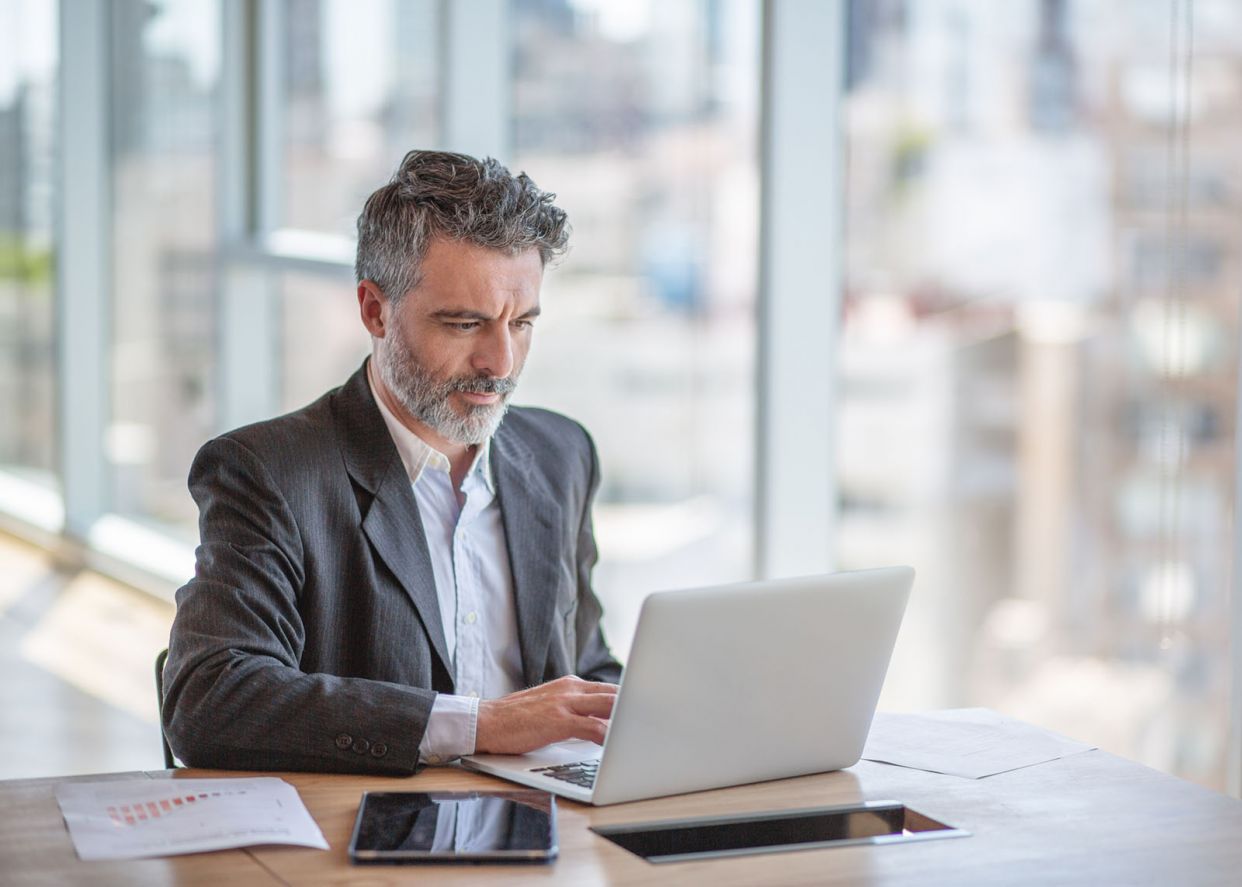 mature business man looking at laptop focused