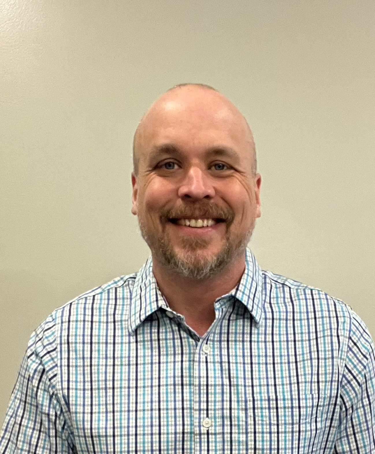 professional photo of Eric Phillips smiling at the camera
