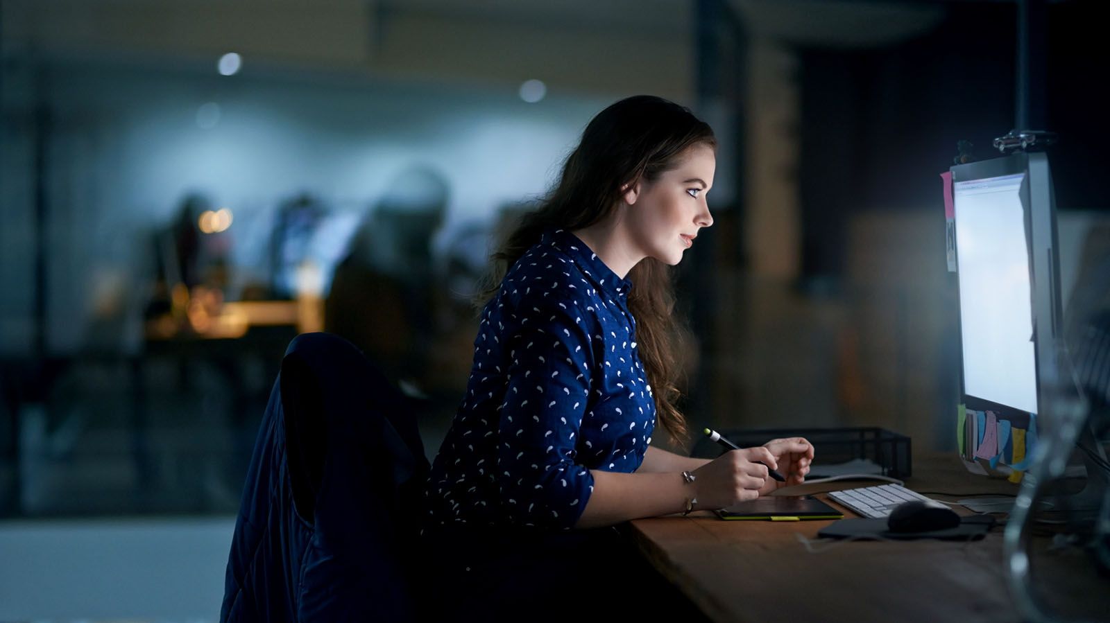 young woman associate working late into night