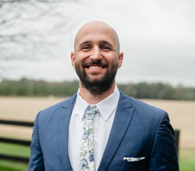 professional photo of Jared smiling at the camera