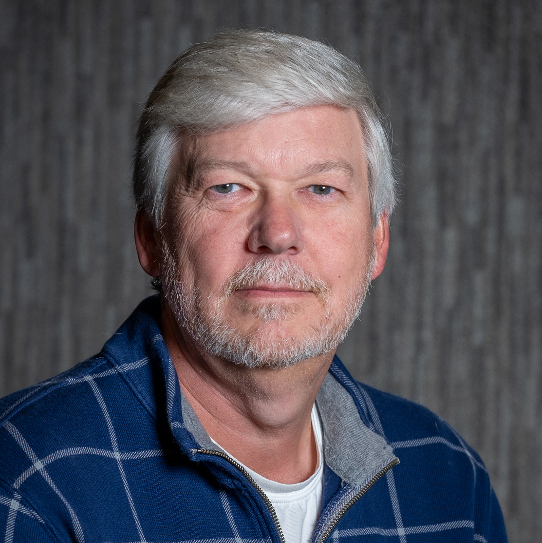 professional photo of Kevin Garbacik smiling with a closed mouth